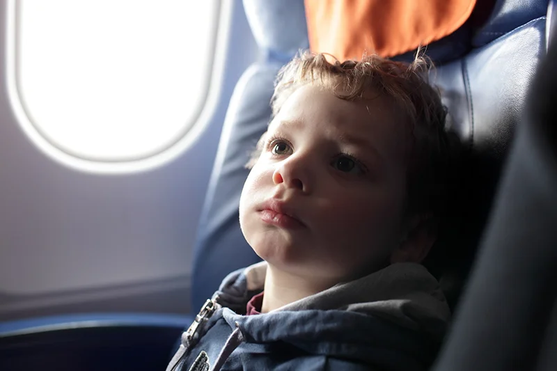 young boy in airplane seat