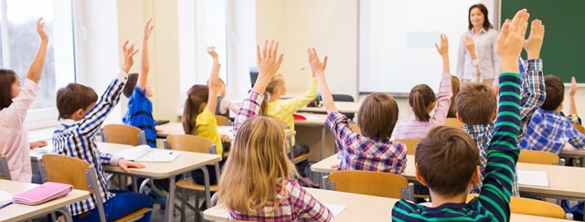 Students Raising Hands in classroom
