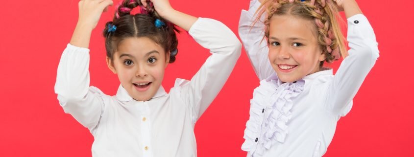 Young girls modeling the best hairstyles to prevent head lice.